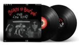 Text: "Beasts of Bourbon - The Low Road". Zwei schwarze Schallplatten mit einem Coverfoto von fünf Personen in einem Auto., 2 LPs