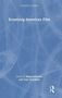 Text: "Screening American Film", "Edited by Nessa Johnston and Gary Needham". Helles, abstraktes Muster auf blauem Hintergrund., Buch