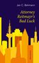 "Jan C. Behmann - Attorney Reitmayr's Bad Luck." Skyline aus gelben und orangen Gebäuden vor dunklem Hintergrund., Buch