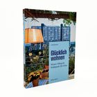Ein Buchcover mit dem Text: "Glücklich wohnen. Wiener Alltag im Wohnpark Alt-Erlaa" von Uschi Korda.