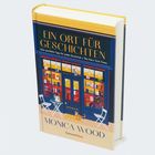 Buchtitel: "Ein Ort für Geschichten." Autor: Monica Wood. Cover zeigt eine gemütliche Buchhandlung mit Stühlen und einer Katze.