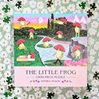 "The Little Frog", 1.000 Teile Puzzle. Illustration von Fröschen mit Fliegenpilzhüten, die in einer Fantasielandschaft tanzen.