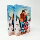 Titel: "Fall in Love" von Romana Stauffer. Zwei Bücher mit einem Paar in winterlicher Landschaft, Schnee und Elch im Hintergrund.