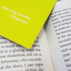 Text auf gelbem Hintergrund: "Not only books. Classics." Ein offenes Buch mit gedrucktem Text.