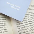 Text: "Not only books. Classics." Ein Buch liegt teils verdeckt auf einem offenen Buch, dessen Text teilweise lesbar ist.