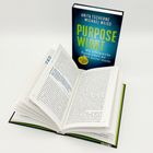 Zwei Bücher. Eines offen, das andere zeigt den Titel: "PURPOSE WIRKT" von Anita Tscherne und Michael Weiss.