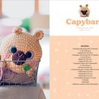 "Capybara, Schwierigkeitsgrad: einfach, Größe: ca. 20 cm. MATERIAL: Scheepjes Big Darling, Little Darling, Catona. Häkelanleitung." 

Eine gehäkelte Figur mit großen Augen in einem Korb.