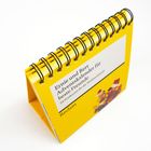 "Ernie und Bert Adventskalender für beste Freunde. 24 Postkarten für die Weihnachtszeit." Gelbes Spiralbuch mit Figuren.