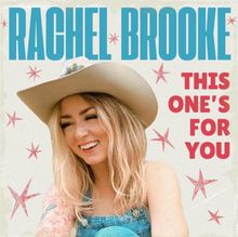 Oben steht „RACHEL BROOKE“ in blau, rechts „THIS ONE’S FOR YOU“ in rot. Eine lachende Frau mit Cowboyhut.
