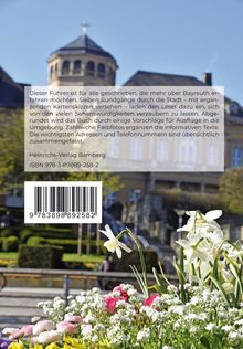Text mit Buchbeschreibung über Bayreuth-Reiseführer vor einer verschwommenen Kirche und einem frühlingshaften Blumenbeet.