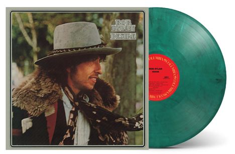 Text: "Bob Dylan Desire". Das Cover zeigt eine Person mit Hut und Fellmantel; daneben eine grüne Vinyl-Schallplatte.