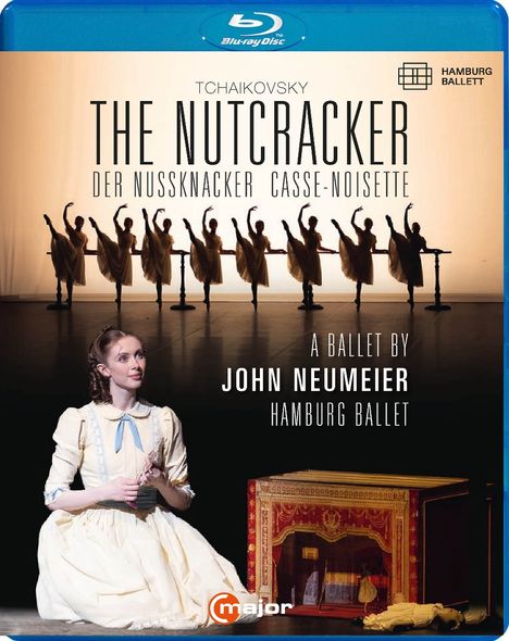 Tchaikovsky "The Nutcracker" Hamburg Ballett. Tänzer in einer Reihe, davor eine Frau in einem weißen Kleid kniend.