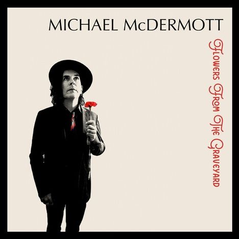 "MICHAEL McDERMOTT" oben, "Flowers From The Graveyard" rechts in Rot. Mann mit Hut hält rote Blume.