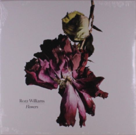 Text: "Rozz Williams Flowers". 
Darstellung: Verwelkte, dunkle Blume vor weißem Hintergrund.