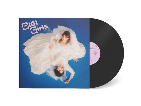 Auf blauem Hintergrund steht "GiGi Girls", darunter zwei Frauen in weißen Kleidern, ein Schallplatten-Cover mit Vinyl.