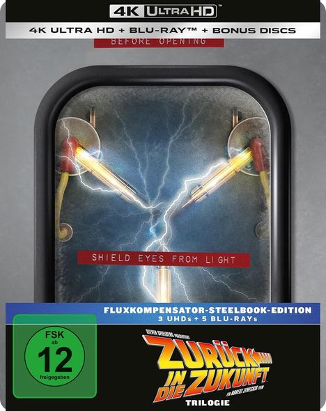 Texte: "4K ULTRA HD + BLU-RAY™ + BONUS DISCS", "SHIELD EYES FROM LIGHT", "FLUXKOMPENSATOR-STEELBOOK-EDITION", "ZURÜCK IN DIE ZUKUNFT". Ein farbiges Logo und ein technisches Display.