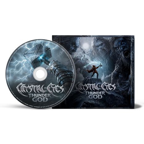 CD und Hülle mit "Mystic Eyes - Thunder God". Illustration eines Kriegers mit Hammer und riesigen Köpfen im Hintergrund.