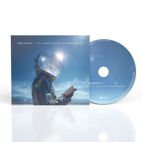 "The Script / The User's Guide to Being Human" steht auf einem Albumcover. Ein Astronaut liest ein Buch vor einem blauen Himmel.