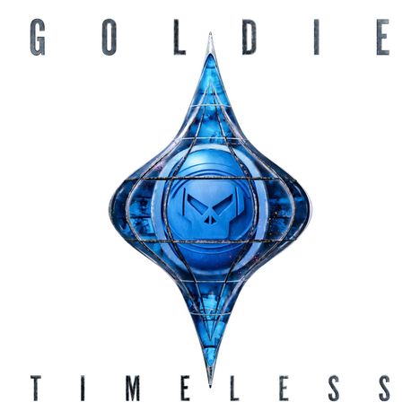 "GOLDIE" oben, "TIMELESS" unten. In der Mitte ein blaues, geometrisches Emblem mit einem stilisierten Gesicht.