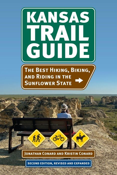 "Kansas Trail Guide: The Best Hiking, Biking, and Riding in the Sunflower State." Ein Wanderer sitzt auf einer Bank.