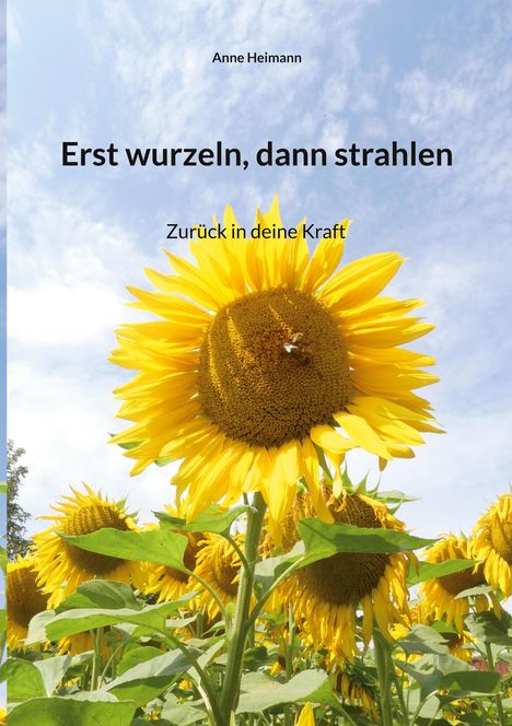 „Erst wurzeln, dann strahlen. Zurück in deine Kraft.“ Große Sonnenblumen unter blauem Himmel.