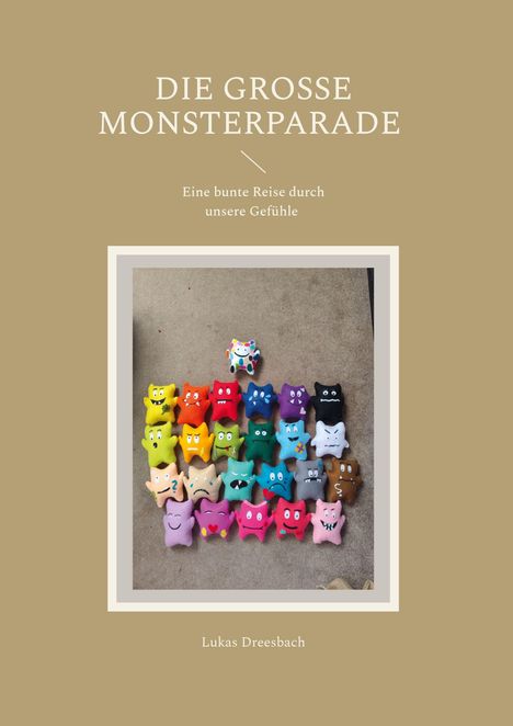 Text: "DIE GROSSE MONSTERPARADE", "Eine bunte Reise durch unsere Gefühle", "Lukas Dreesbach". 

Foto von bunten Stoffmonstern.