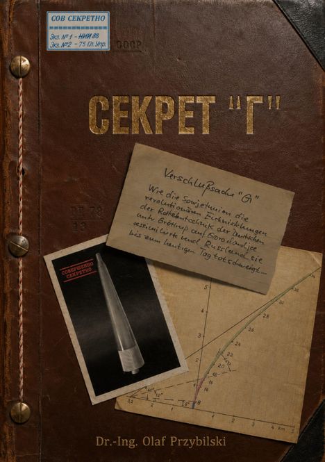 Notiz: "Verschlußsache 'G'". Diagramm, Foto einer Rakete, aufgeklapptes Buch. Dekorativ gebunden, Lederoptik.