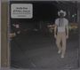 "Orville Peck" und "APPALOOSA." Ein Mann mit Cowboyhut und Fransenmaske steht nachts auf einer Straße.