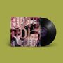 Auf einem Vinyl-Cover steht „BUTTHOLE SURFERS“. Der Hintergrund zeigt verzerrte Gesichter.
