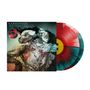 Text: "KARNIVOOL ASYMMETRY", "ASYMMETRY BLOT OF SYMMETRY VINYL".  
Illustration: Abstrakte Figuren mit Linien und verschwommenem Hintergrund.  
Vinyl-Schallplatte in Rot und Blau.