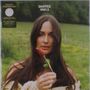 Text oben: "DEEPER WELL". Eine Frau mit langen Haaren hält eine rote Blume, Hintergrund ist eine grüne Wiese.