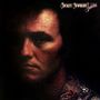 "Mickey Newbury Lovers" oben rechts. Dunkles, stimmungsvolles Porträt eines nachdenklichen Mannes im Schatten.