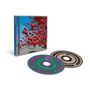 Text: "The Cranberries." CD-Hülle mit schwebenden roten Kugeln vor blauem Himmel. Zwei CDs mit bunten Streifen.