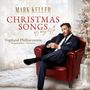 "Mark Keller: Christmas Songs of my Life. Vogtland-Philharmonie Singakademie Chemnitz." Mann im Anzug auf rotem Sessel.