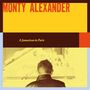 Text: "Monty Alexander", "A Jamaican in Paris". Ein Mann von hinten schaut auf ein Klavier.
