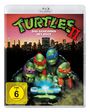 "Turtles II: Das Geheimnis des Ooze" und "FSK ab 6 freigegeben". Vier Schildkröten mit Masken über einer leuchtenden Substanz.