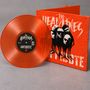 Text: "The Headlines", "Antidote". Eine transparente orangefarbene Vinylplatte lehnt an einem Cover mit Köpfen.