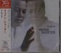 Text: "alegría, WAYNE SHORTER." Japanischer Text vertikal. Person berührt mit dem Finger eine strahlende Stelle.