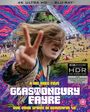 Text: "A Nic Roeg Film, Glastonbury Fayre, The True Spirit in Beautiful 4K." Junge Frau zeigt ein Peace-Zeichen vor bunter Festival-Kulisse.