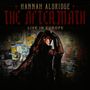 Oben steht: "Hannah Aldridge, The Aftermath, Live in Europe". Frau in schwarzer Spitze vor einer mit Postern bedeckten Wand.