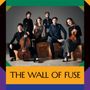 „THE WALL OF FUSE“ steht unten. Sechs Personen posieren mit Instrumenten vor einem neutralen Hintergrund.
