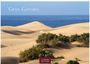 Der Text "GRAN GANARIA" und "2027 CASARES EDITION" steht über einer Wüstenlandschaft mit Sanddünen und Meer.