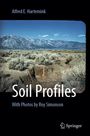 Text: Alfred E. Hartemink, Soil Profiles, With Photos by Roy Simonson. Sicht auf eine trockene Landschaft mit Bergen. Springer-Logo.