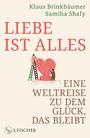 "LIEBE IST ALLES. EINE WELTREISE ZU DEM GLÜCK, DAS BLEIBT." Zwei Figuren arbeiten an einem Herz.
