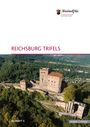 "REICHSBURG TRIFELS" steht groß. Luftaufnahme einer historischen Burg auf bewaldetem Hügel. Oben links ein Wappen und Text.