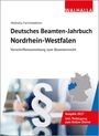 "Deutsches Beamten-Jahrbuch Nordrhein-Westfalen", "Ausgabe 2027". Ein Paragrafenzeichen, eine Person schreibt.