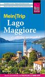 „Mein Trip Lago Maggiore“ steht über einer malerischen Seelandschaft mit Kirchturm und Bergen im Hintergrund.
