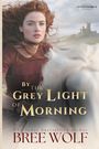 Text: "By the Grey Light of Morning", "Lass of Legend", "USA Today bestselling author Bree Wolf". Frau mit rotem Haar, Burg im Hintergrund.