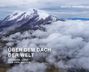 Text: "Über dem Dach der Welt. Ecuador, Land der vier Welten." Martin Köppert. Schneebedeckter Berg, Wolken.